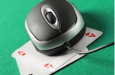 computer mouse sitting on top of a pair of aces