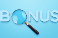 An image of the word 'bonus' with a magnifying glass as the 'O' on a blue background