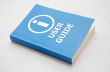 An image of a light blue user guide book isolated on a light grey background 