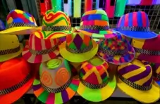 A photo of brightly coloured neon hats with funky designs
