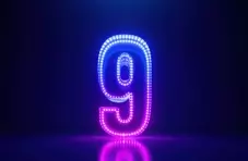 A 3D illustration of a luminous and colourful number 9 on a dark background