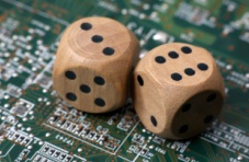 An image of two wooden dice on a green circuit board